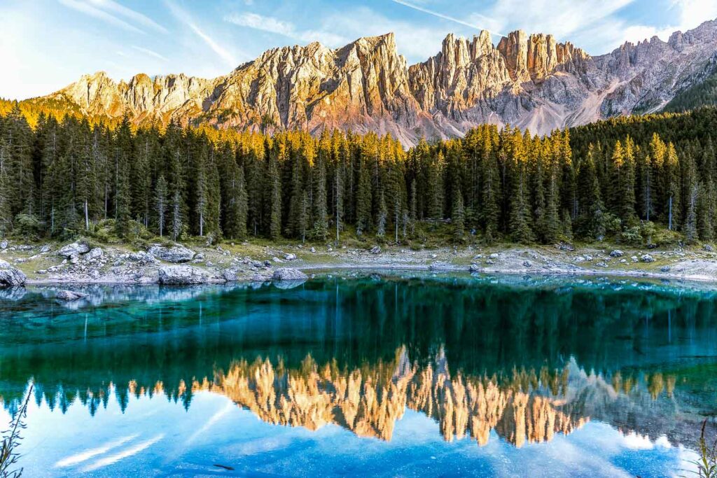 10 Best places to visit in the Dolomites | Italian Trip Abroad 5 The reflections of the Dolomites in the emerald lake water of Carezza Lake