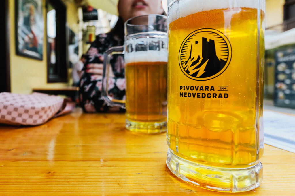 Zagreb Guide: 40 Incredible Things to do in Zagreb discovering hidden gems 10 Beer in Zagreb Croatia - Try the local Pivo in Zagreb old town through cobblestone streets and some food