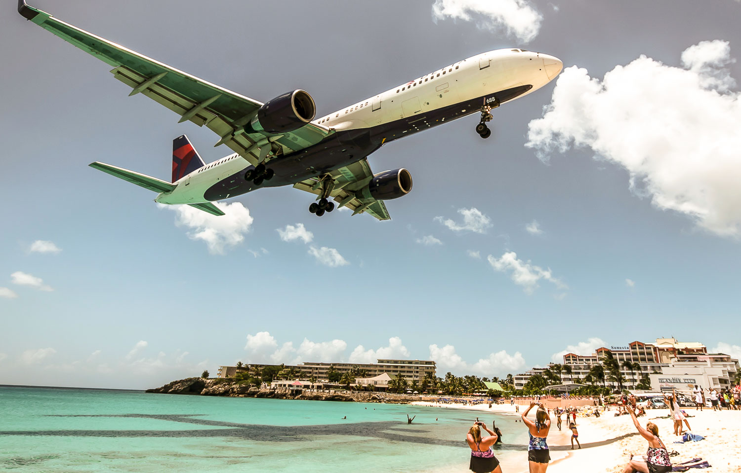 Plane landing nearby the Maho beach in Saint Maarten one of the best photo spots in the Caribbean