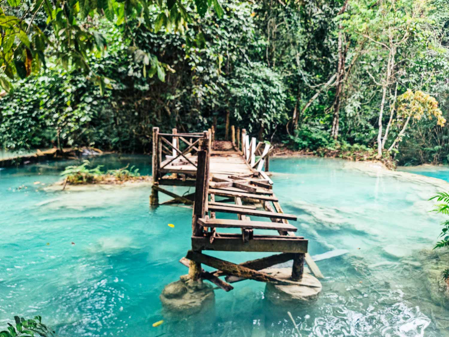 Unveiling the hidden gems: An unforgettable Laos itinerary 2 weeks 22 Kuang Si waterfall bridge and blue emerald water