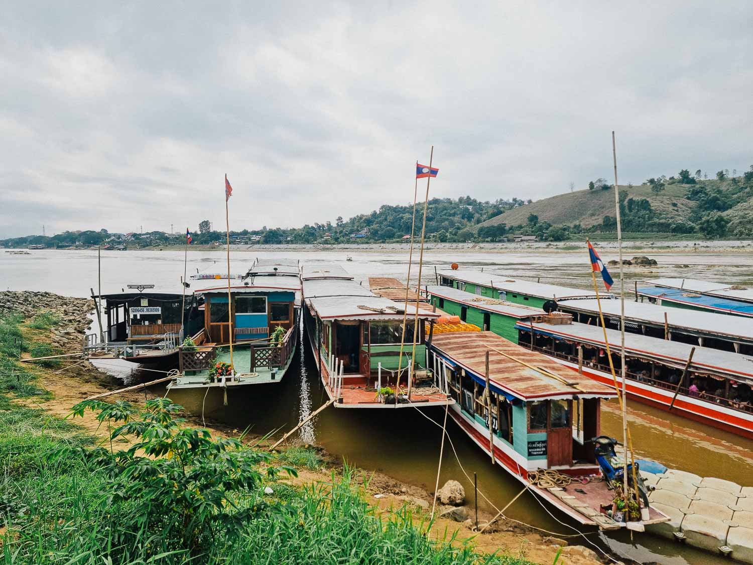 Unveiling the hidden gems: An unforgettable Laos itinerary 2 weeks 2 The boats in Huay Xai Harbour waiting for passengers to embark the journey on the Mekong River to Luang Prabang