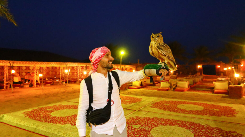 Dubai experiences - Toti holding an owl during a Dubai desert Safari