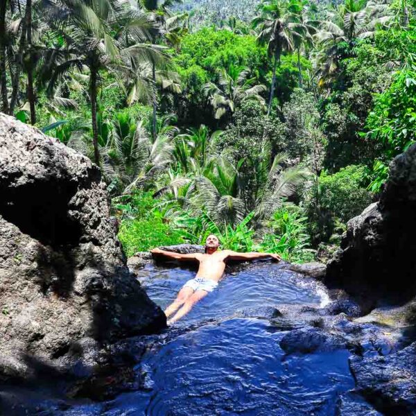 Toti swimming inside the natural pool of Gembleng Waterfall