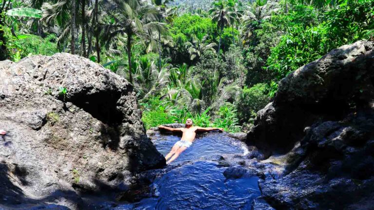 Toti swimming inside the natural pool of Gembleng Waterfall